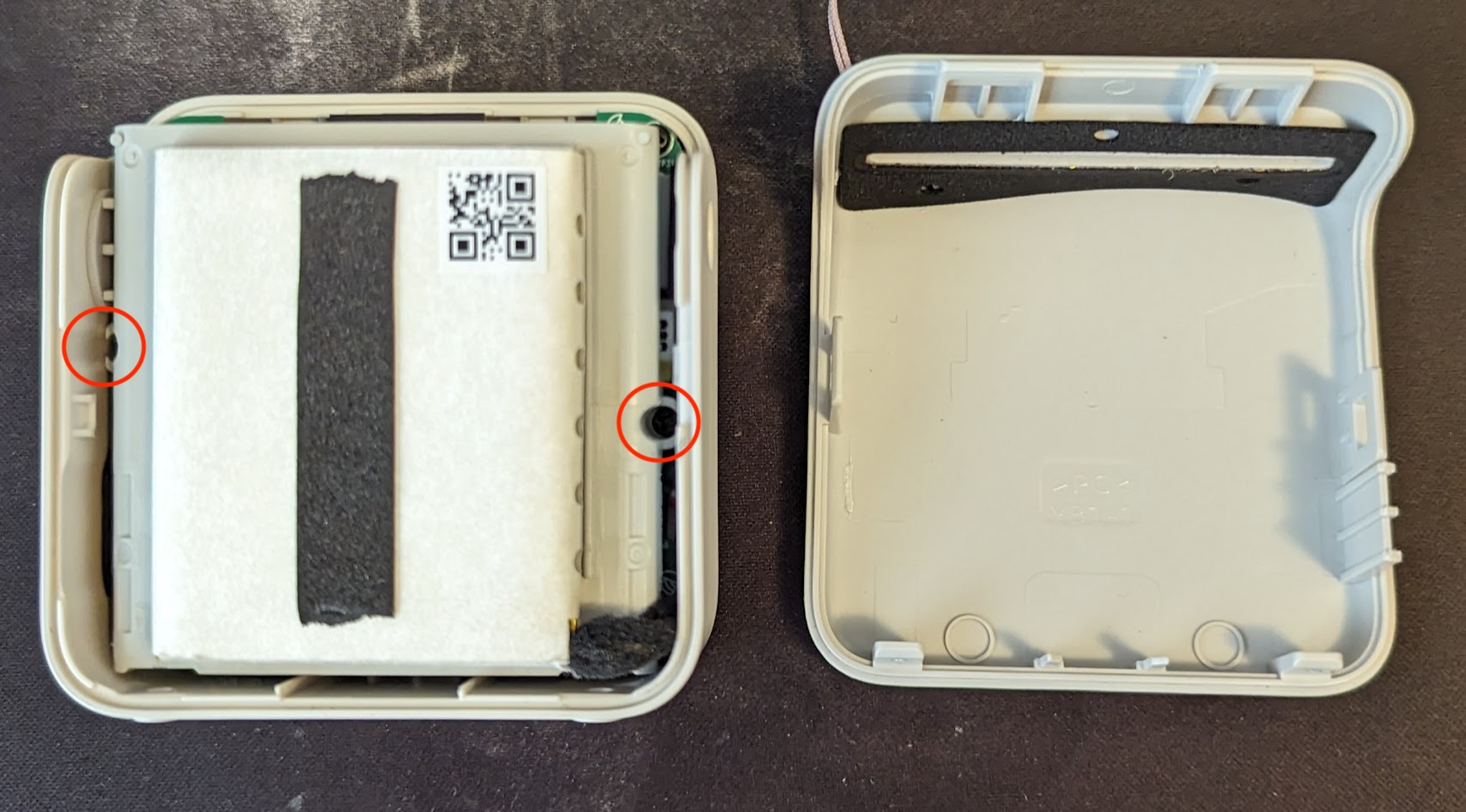 The inside of a yoto mini after opening the two halves of the case, on the left is the battery pack covering the rest of the internals.